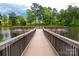 Beautiful lake view with a wooden walkway leading to a relaxing seating area perfect for enjoying nature at 41062 Calla Lily St, Fort Mill, SC 29707