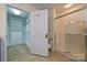 Bathroom with a shower and walk-in closet, providing plenty of storage space at 4709 Polo Gate Blvd, Charlotte, NC 28216