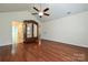 Bedroom featuring hardwood floors, ceiling fan, armoire, and access to other rooms at 4709 Polo Gate Blvd, Charlotte, NC 28216