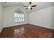 Spacious bedroom with hardwood floors, a ceiling fan, and a large window at 4709 Polo Gate Blvd, Charlotte, NC 28216