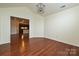 Dining room with hardwood floors, a modern light fixture, and access to the kitchen at 4709 Polo Gate Blvd, Charlotte, NC 28216