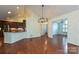 Dining area with hardwood floors, modern light fixture, and access to the kitchen at 4709 Polo Gate Blvd, Charlotte, NC 28216