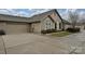 Exterior elevation with stone accents, neutral siding, and a spacious driveway at 4709 Polo Gate Blvd, Charlotte, NC 28216