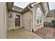 Exterior view of a stone home showcasing the front entrance and an arched window at 4709 Polo Gate Blvd, Charlotte, NC 28216