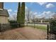 Inviting front patio with brick flooring and wrought iron railing, complemented by manicured shrubs at 4709 Polo Gate Blvd, Charlotte, NC 28216