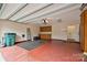 Spacious two-car garage features a red floor and built-in cabinets and work bench at 4709 Polo Gate Blvd, Charlotte, NC 28216