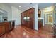 Kitchen with wooden cabinets, granite countertops, stainless steel dishwasher, and views into other rooms at 4709 Polo Gate Blvd, Charlotte, NC 28216