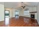 Bright living room featuring hardwood floors, fireplace, and abundant natural light from a large arched window at 4709 Polo Gate Blvd, Charlotte, NC 28216