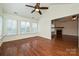 Bright living room featuring hardwood floors, a ceiling fan, and a view into the next room at 4709 Polo Gate Blvd, Charlotte, NC 28216