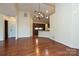 Open-concept living room with hardwood floors, modern lighting, and views of the kitchen at 4709 Polo Gate Blvd, Charlotte, NC 28216