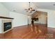 Spacious living room featuring a fireplace, hardwood floors, and access to the kitchen at 4709 Polo Gate Blvd, Charlotte, NC 28216