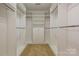 Walk-in closet with carpet flooring and wooden rods and shelving, providing plenty of storage at 4709 Polo Gate Blvd, Charlotte, NC 28216