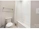 Bright bathroom features a tub and shower combination with a white tile surround at 5608 Closeburn Rd, Charlotte, NC 28210