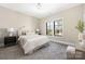 Neutral bedroom with soft carpet, stylish decor, and natural light at 5608 Closeburn Rd, Charlotte, NC 28210