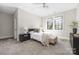 Bedroom with natural lighting featuring a large window, ceiling fan, and neutral-toned decor at 5608 Closeburn Rd, Charlotte, NC 28210