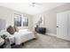 Bright bedroom features a large window, ceiling fan, and dark-toned furniture at 5608 Closeburn Rd, Charlotte, NC 28210