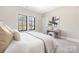 Neutral bedroom with soft carpet, side table and decor at 5608 Closeburn Rd, Charlotte, NC 28210