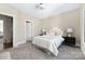 Neutral bedroom with two bedside tables, soft carpet and a view to the front yard at 5608 Closeburn Rd, Charlotte, NC 28210