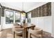 Well-lit dining room featuring a wooden table, modern light fixture, and decorative wallpaper at 5608 Closeburn Rd, Charlotte, NC 28210