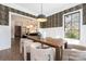 Dining area features hardwood floors, designer wallpaper and a dark wood table with seating for eight at 5608 Closeburn Rd, Charlotte, NC 28210