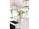 Kitchen island with white marble countertop, stainless sink and faucet, with pendant lighting at 5608 Closeburn Rd, Charlotte, NC 28210