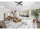 Bright living room featuring a comfortable sectional sofa, ceiling fan, and an open layout to the kitchen at 5608 Closeburn Rd, Charlotte, NC 28210