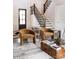 Cozy living room featuring a staircase, wooden table, and decorative rug at 5608 Closeburn Rd, Charlotte, NC 28210