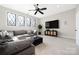 Comfortable living room features a large grey couch, mounted TV and a ceiling fan at 5608 Closeburn Rd, Charlotte, NC 28210