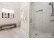 Bright bathroom showcasing a glass shower, a window with blinds, and a patterned accent rug at 5608 Closeburn Rd, Charlotte, NC 28210