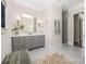 Elegant bathroom with double vanity, gray cabinets, and a glass-enclosed shower with tile surround at 5608 Closeburn Rd, Charlotte, NC 28210