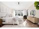 Bright main bedroom featuring hardwood floors, a ceiling fan, and black trimmed windows at 5608 Closeburn Rd, Charlotte, NC 28210