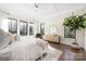 Sun-filled main bedroom featuring three large windows, hardwood floors, and a decorative tree in a pot at 5608 Closeburn Rd, Charlotte, NC 28210