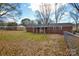 Brick home with a fenced backyard and a covered porch, set amongst mature trees at 571 Amity Se Ave, Concord, NC 28025