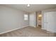 Bedroom with neutral walls, carpet, a window, and an access to a bathroom at 571 Amity Se Ave, Concord, NC 28025