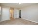 Bedroom with neutral walls, carpet, and accesses to the hallway and bathroom at 571 Amity Se Ave, Concord, NC 28025