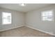 Bedroom featuring neutral paint, carpet, and two windows at 571 Amity Se Ave, Concord, NC 28025