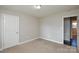 Bedroom featuring neutral paint, carpet, white door and a window for natural light at 571 Amity Se Ave, Concord, NC 28025