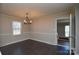 Dining room boasts a chandelier, a neutral color scheme, and a bright window at 571 Amity Se Ave, Concord, NC 28025