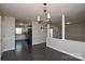 Dining room and kitchen are interconnected and include grey walls and dark floors at 571 Amity Se Ave, Concord, NC 28025