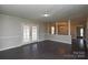 Living room features a neutral color scheme, grey walls, and a view of the backyard through the french doors at 571 Amity Se Ave, Concord, NC 28025