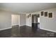 View of an empty living room featuring dark floors, and grey neutral-toned walls at 571 Amity Se Ave, Concord, NC 28025