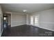 Living room features a neutral color scheme, grey walls, and dark floors at 571 Amity Se Ave, Concord, NC 28025