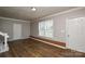 Bright living room with hardwood flooring, large window, and access to doorways at 571 Amity Se Ave, Concord, NC 28025