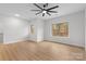 Bright bedroom with two windows, ceiling fan, and wood-look floors at 607 W Stanly St, Stanfield, NC 28163