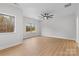 Bright bedroom with two windows, ceiling fan, and wood-look floors at 607 W Stanly St, Stanfield, NC 28163