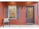 Welcoming front porch with cozy chair, a window with shutters, and a stylish front door at 607 W Stanly St, Stanfield, NC 28163