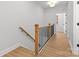 Hallway featuring modern design with wooden handrail and access to multiple rooms at 607 W Stanly St, Stanfield, NC 28163