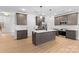 Modern kitchen featuring stainless steel appliances, a central island, and stylish gray cabinetry at 607 W Stanly St, Stanfield, NC 28163