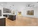 Modern open-concept kitchen featuring stainless steel appliances, island, and hardwood floors at 607 W Stanly St, Stanfield, NC 28163