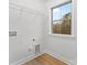 Bright laundry room with utility sink, window, and washer/dryer hookups at 607 W Stanly St, Stanfield, NC 28163